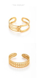 Detail of adjustable gold hammered leaf and pig nose buckle cuff bracelets on white backdrop