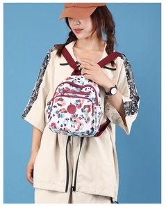 Detail of floral nylon mini backpack with adjustable straps and multi-zipper pockets