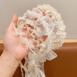 White lace headband for girls with delicate floral ribbons and pearls for hair styling