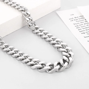 Close-up of polished silver Miami Cuban link chain necklace for men with glossy finish