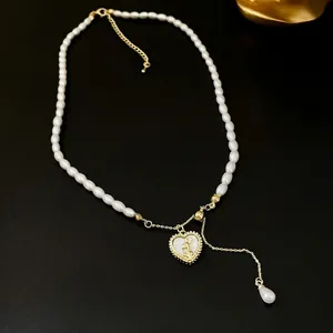 Elegant French style pearl necklace with golden heart rabbit pendant on black leather background