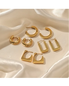 Detailed close-up of 14K gold plated stainless steel geometric earring set on white silk