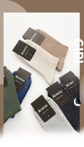 Close-up of combed cotton men's crew socks with vertical ribbed texture in six colors