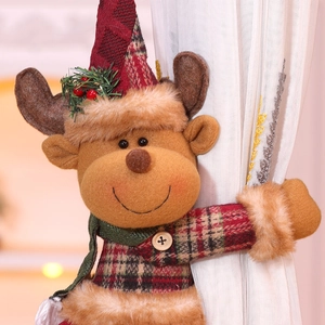 Detail of Christmas reindeer curtain tieback with red plaid hat and festive berries
