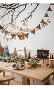 Detail of rustic birch wood candle holders and snowy mini Christmas trees on table