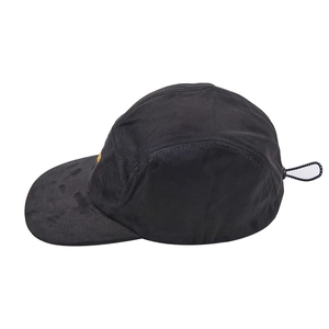 Side view of a black 5-panel camping cap with yellow brand patch and adjustable toggle