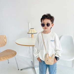 Detailed shot of a khaki bunny-shaped kids crossbody bag with yellow flower decorations
