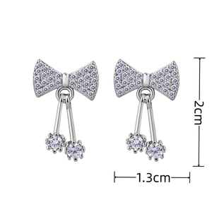 Detailed size view of silver bow earrings with stones, 2cm height and 1.3cm width