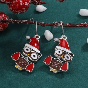 Festive Christmas owl drop earrings with red holiday hat on rustic winter branch