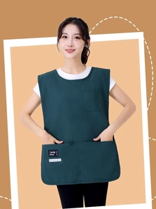 Detail of dark green barista apron vest with two large front pockets for tools