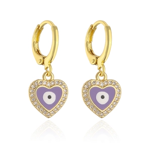 Macro shot of gold heart earrings featuring purple evil eye inlay and zircon halo