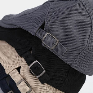 Detail of adjustable vintage metal buckle and mesh knit texture on solid color beret hats