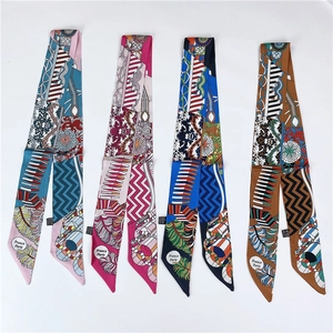 Vertical flat lay of four colorful silk twilly scarves with intricate ethnic patterns