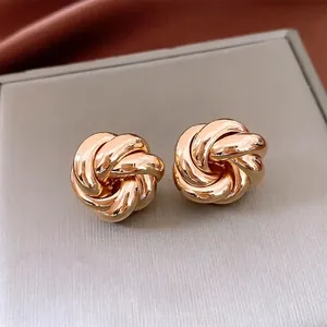 Exquisite rose gold knotted vortex flower earrings in a polished metallic hollow design