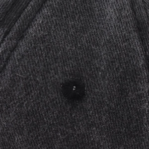 Close-up of embroidered eyelet and washed cotton fiber texture on black baseball cap