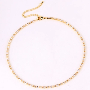 Detailed top view of gold tennis necklace with emerald cut cubic zirconia and extension chain