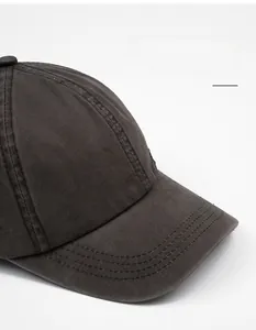 Macro detail of dark grey washed cotton baseball cap featuring reinforced wide brim stitching