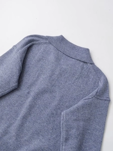 Close-up detail of cashmere blend polo knit sweater neckline in soft dusty blue