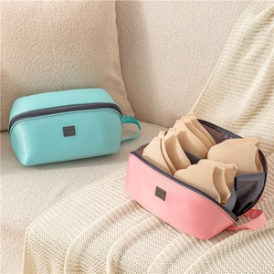 Portable travel storage organizers in blue and pink for underwear and accessories