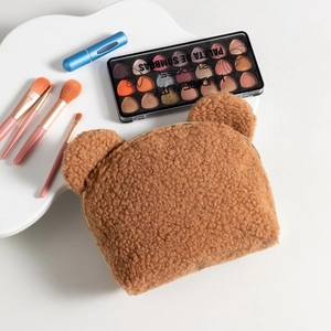 Detail of teddy plush bear cosmetic bag with metal zipper and 3D ears texture