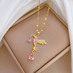 Elegant gold titanium necklace with a hummingbird pendant encrusted with pink gems and diamonds