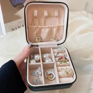 Portable black leather jewelry organizer box with multi-compartment storage for rings