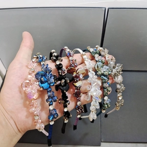 Hand-held detailed display of various colored crystal and rhinestone headbands