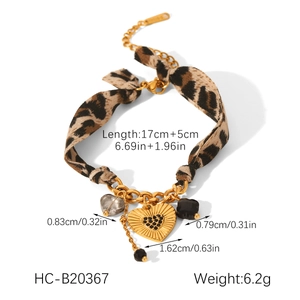 Detailed view of leopard print chain bracelet with gold heart charms and crystals