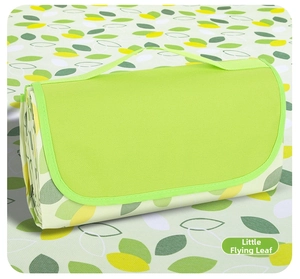 Detail of leaf pattern oxford picnic mat with portable handle and folding cover