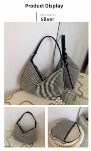 Detail shot of silver rhinestone baguette bag with black leather strap and chain