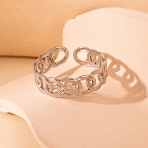 Artistic detail of silver chain-link stainless steel open ring on a textured background