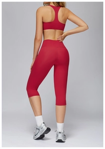 Rear view of red brushed racerback yoga bra and high-waisted 3/4 length fitness leggings