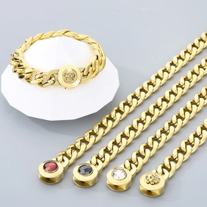 Detailed set of gold cuban necklaces and skull bracelet with colorful gemstone clasps