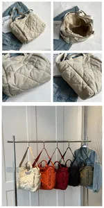 Detail view of large quilted tote bags in five colors with zipper and pocket features