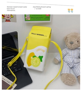 Detail of lemon-themed milk carton crossbody bag with yellow print and adjustable PU strap