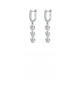 Macro shot of S925 sterling silver long earrings with three round sparkling cubic zirconia