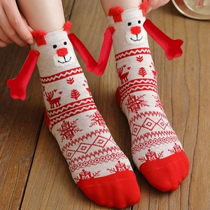 Close-up of Christmas cotton socks with reindeer patterns and 3D doll face decoration