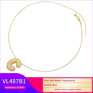 Detailed view of the gold-plated brass 'C' balloon pendant with cubic zirconia stones