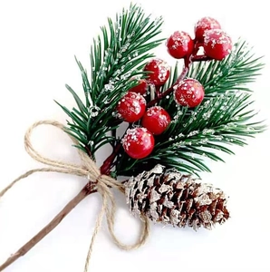 Artificial Christmas pine branch with red berries and pinecones on a white background