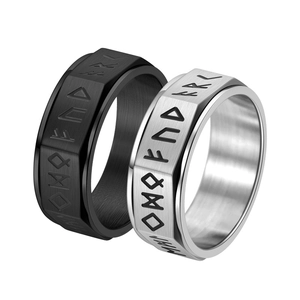 Detail of Viking spinner rings with Nordic runes in silver and black brushed steel