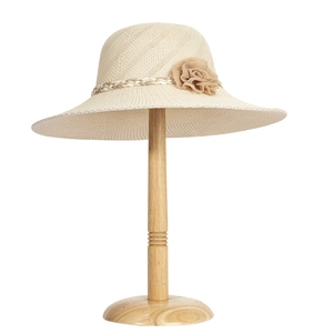 Close-up of beige raffia sun hat with woven strap and 3D fabric flower detail