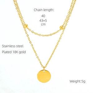 Macro detail of double-layer 18K gold plated stainless steel necklace with round pendant