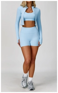 Detailed view of light blue yoga set featuring thumb-hole jacket and high-waist shorts