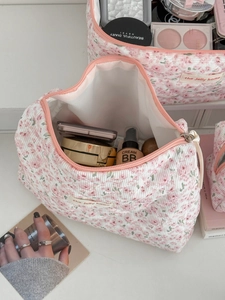 Top view of open floral corduroy toiletry bag showing spacious interior and quilting