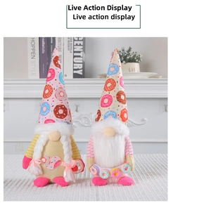 Detail of plush Christmas gnomes with donut-patterned hats and braided hair
