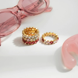 Detail of gold plated stainless steel rings with colorful round cubic zirconia stones