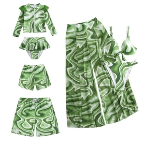 Matching family swimwear set with green and white marble swirl pattern for beach outings