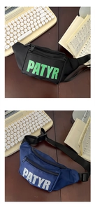 Close-up of nylon kids chest bags in black and blue with PATYR letter print detail