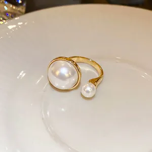 Elegant gold-plated open ring with asymmetric white pearls and adjustable band design