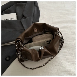 Detail view of the deep brown leather cloud bag interior showing storage capacity